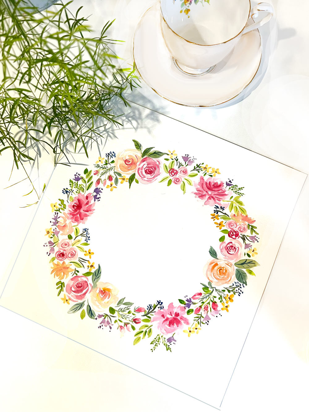 An original wreath flower painting featuring pink, purple blue and orange flowers &nbsp;painted in a circle.